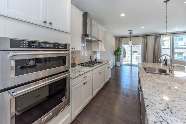 2763 Polson St, Ann Arbor, MI 48105 - kitchen with stainless steel appliances, wall chimney range hood, dark wood-style flooring, healthy amount of natural light, and recessed lighting