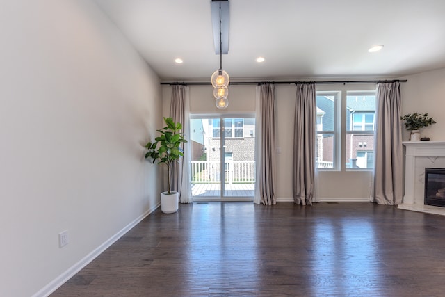 2763 Polson St, Ann Arbor, MI 48105 - unfurnished living room featuring plenty of natural light, a premium fireplace, dark wood-style floors, and recessed lighting