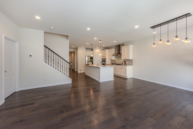 2763 Polson St, Ann Arbor, MI 48105 - unfurnished living room featuring dark wood finished floors, stairway, and recessed lighting