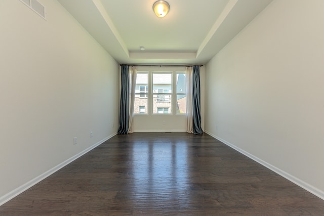 2763 Polson St, Ann Arbor, MI 48105 - empty room featuring a tray ceiling and dark wood-type flooring