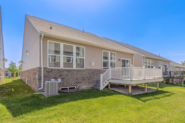 2763 Polson St, Ann Arbor, MI 48105 - rear view of property featuring a wooden deck, brick siding, and a lawn