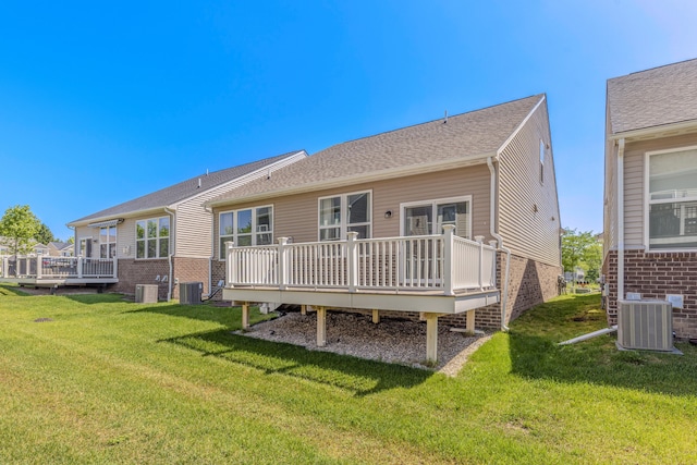 2763 Polson St, Ann Arbor, MI 48105 - back of house with a deck, brick siding, and a yard