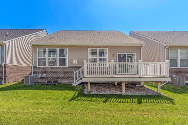 2763 Polson St, Ann Arbor, MI 48105 - rear view of house featuring brick siding, a deck, and a lawn