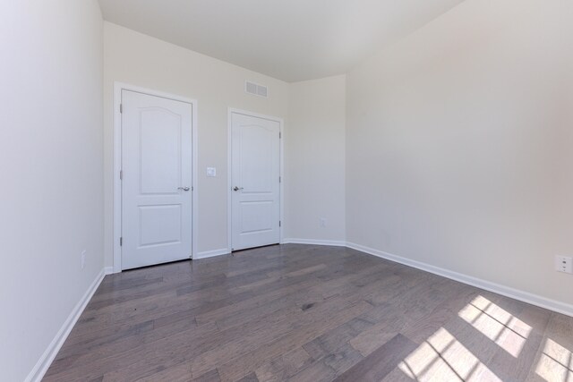 2763 Polson St, Ann Arbor, MI 48105 - unfurnished bedroom featuring dark wood-type flooring and baseboards