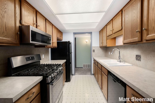230 S State St Unit 83, Zeeland, MI 49464 - kitchen with appliances with stainless steel finishes, tasteful backsplash, and light countertops