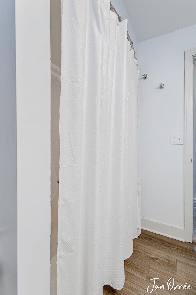 6116 Eastern Ave SE, Grand Rapids, MI 49508 - full bathroom with wood finished floors and a shower with curtain