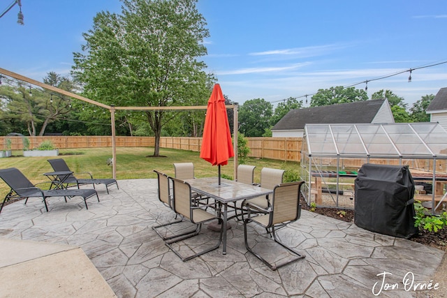 6116 Eastern Ave SE, Grand Rapids, MI 49508 - fenced backyard with an exterior structure, area for grilling, a patio area, an outdoor structure, and outdoor dining area