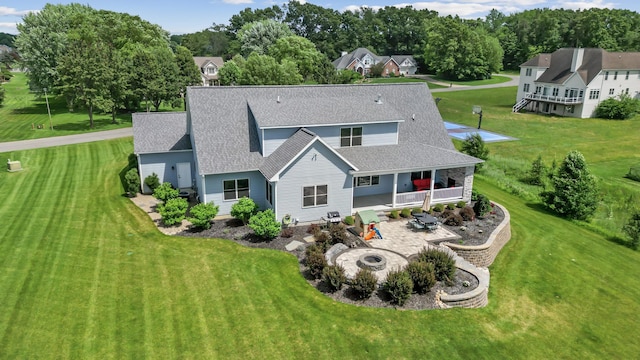 46140 Finch St, Mattawan, MI 49071 - rear view of house with an outdoor fire pit, a patio area, a shingled roof, and a yard