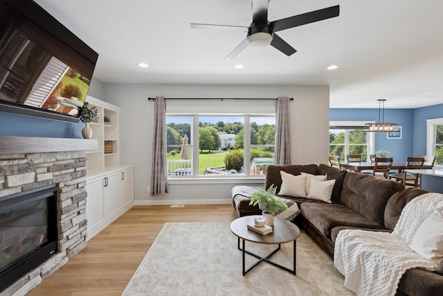 46140 Finch St, Mattawan, MI 49071 - living room with a fireplace, light wood-type flooring, a chandelier, recessed lighting, and ceiling fan