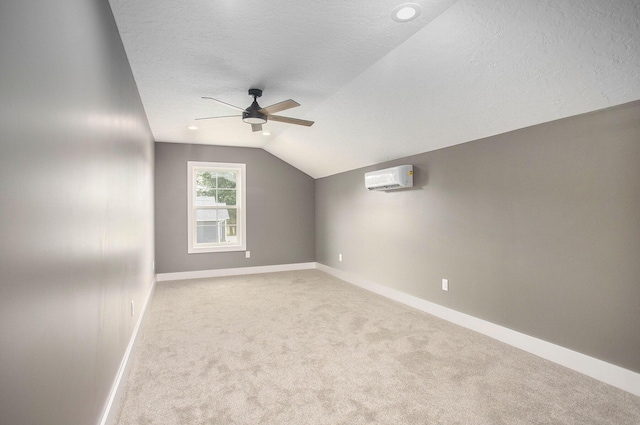 17756 Brad Ln, Three Rivers, MI 49093 - unfurnished room featuring a ceiling fan, lofted ceiling, a wall unit AC, carpet flooring, and a textured ceiling
