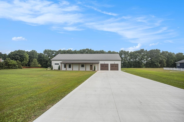 17756 Brad Ln, Three Rivers, MI 49093 - modern farmhouse style home with a front lawn, an attached garage, concrete driveway, a metal roof, and view of scattered trees