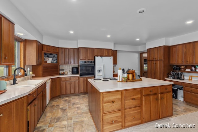 261 W 28th St, Holland, MI 49423 - kitchen featuring white appliances, backsplash, recessed lighting, stone finish flooring, and light countertops