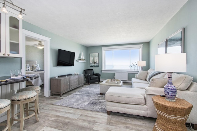 225 N Shore Dr Unit 302, South Haven, MI 49090 - living room featuring healthy amount of natural light, light wood-type flooring, ceiling fan, and a textured ceiling