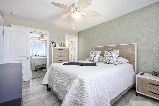 225 N Shore Dr Unit 302, South Haven, MI 49090 - bedroom with wood finished floors, a ceiling fan, and wallpapered walls