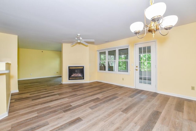 2208 Parkview Ave, Kalamazoo, MI 49008 - unfurnished living room with a glass covered fireplace, a chandelier, wood finished floors, and ceiling fan