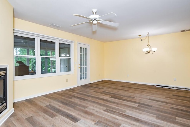 2208 Parkview Ave, Kalamazoo, MI 49008 - unfurnished room featuring ceiling fan, wood finished floors, a chandelier, and a baseboard radiator
