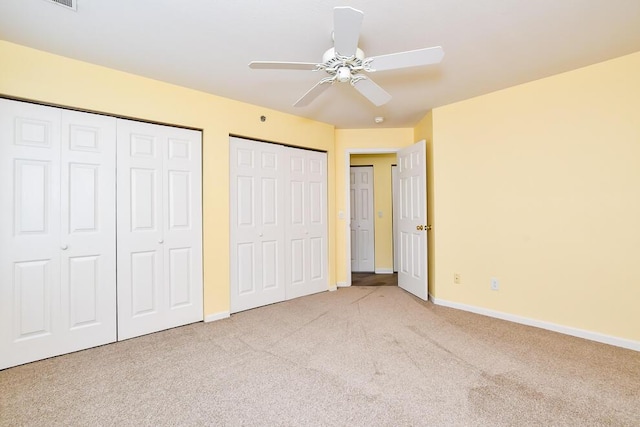 2208 Parkview Ave, Kalamazoo, MI 49008 - unfurnished bedroom with multiple closets, carpet, and ceiling fan