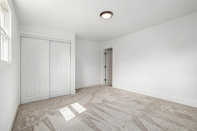 802 Clinton St, Marshall, MI 49068 - unfurnished bedroom featuring carpet floors and a closet