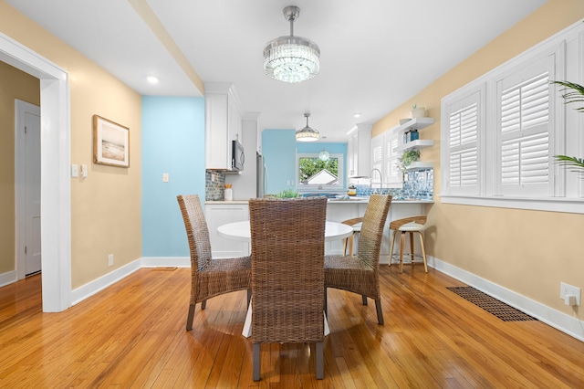 510 Wayne St, Saint Joseph, MI 49085 - dining area with light wood finished floors, a chandelier, and recessed lighting