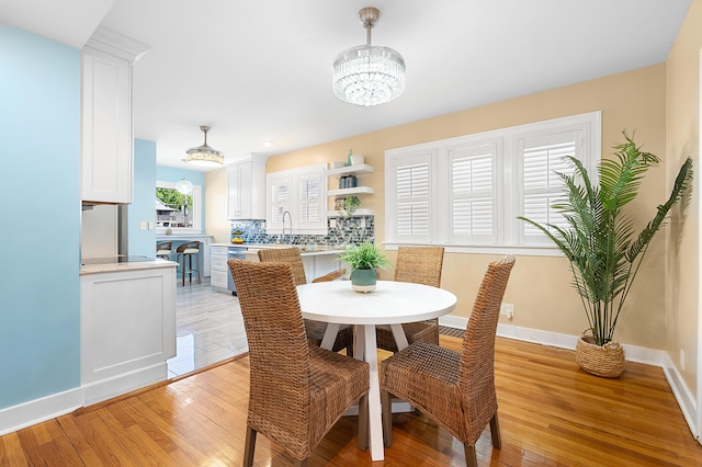 510 Wayne St, Saint Joseph, MI 49085 - dining area featuring light wood-style flooring and a chandelier