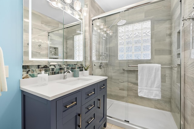 510 Wayne St, Saint Joseph, MI 49085 - bathroom featuring vanity, a stall shower, and backsplash