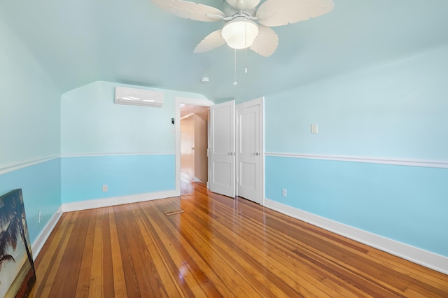 510 Wayne St, Saint Joseph, MI 49085 - spare room featuring a wall mounted AC, a ceiling fan, hardwood / wood-style floors, and vaulted ceiling