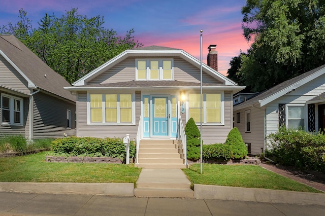 510 Wayne St, Saint Joseph, MI 49085 - bungalow-style house featuring a front yard and a chimney