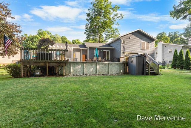 2845 Ridgecrest St SW, Byron Center, MI 49315 - rear view of house with a shed, a wooden deck, and a yard