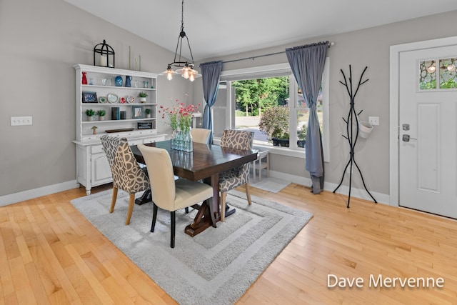 2845 Ridgecrest St SW, Byron Center, MI 49315 - dining area featuring healthy amount of natural light, light wood finished floors, a chandelier, and vaulted ceiling
