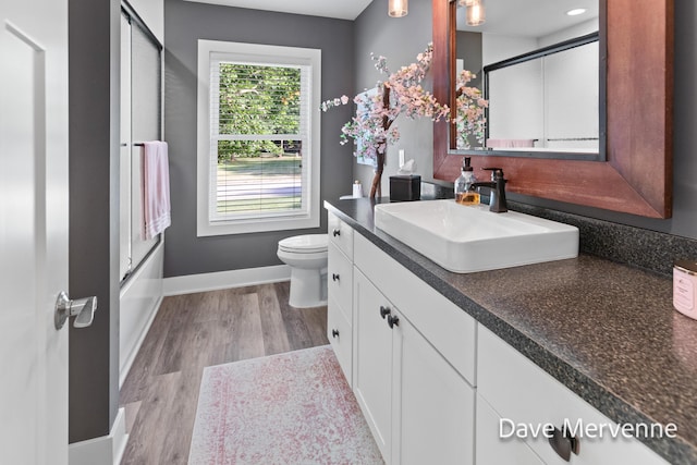 2845 Ridgecrest St SW, Byron Center, MI 49315 - bathroom with vanity, wood finished floors, and shower / bath combination with glass door