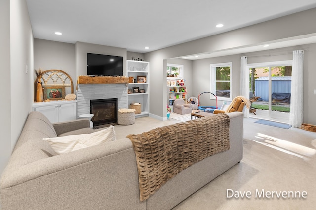2845 Ridgecrest St SW, Byron Center, MI 49315 - living room featuring light colored carpet, recessed lighting, and a glass covered fireplace