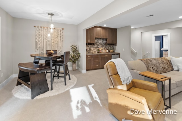 2845 Ridgecrest St SW, Byron Center, MI 49315 - dining space with stairs, light carpet, recessed lighting, and bar area