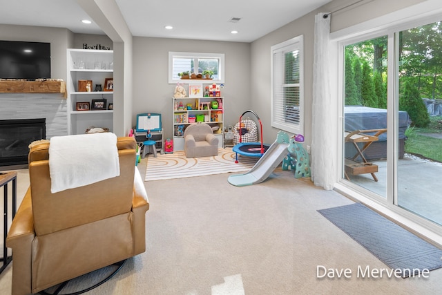 2845 Ridgecrest St SW, Byron Center, MI 49315 - game room featuring a glass covered fireplace, recessed lighting, and carpet