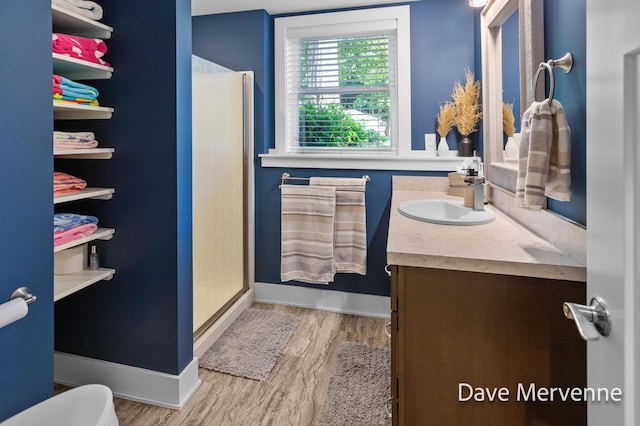 2845 Ridgecrest St SW, Byron Center, MI 49315 - bathroom with vanity, wood finished floors, and a stall shower
