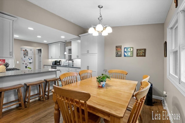 4712 Shank St NE, Rockford, MI 49341 - dining room featuring wood finished floors, recessed lighting, and a chandelier