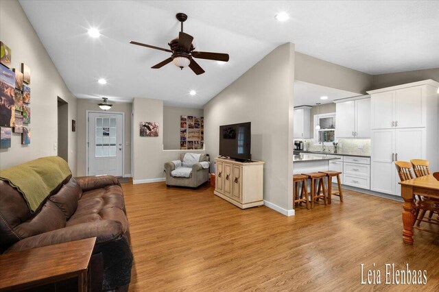 4712 Shank St NE, Rockford, MI 49341 - living area featuring light wood-type flooring, vaulted ceiling, ceiling fan, and recessed lighting
