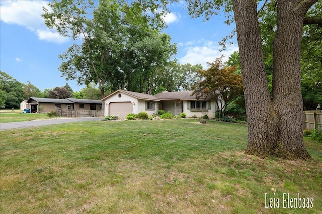 4712 Shank St NE, Rockford, MI 49341 - ranch-style home with asphalt driveway and an attached garage