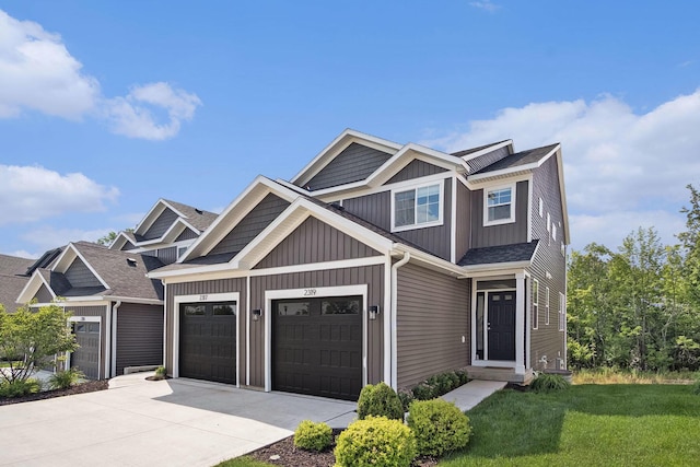 2319 Watertown Way, Grand Rapids, MI 49505 - view of front of house with driveway, a front yard, board and batten siding, a garage, and a shingled roof