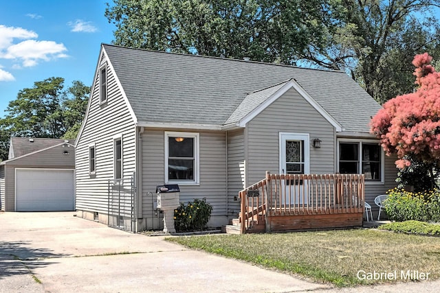 3725 Colby Ave SW, Wyoming, MI 49509 - view of front of property with an outbuilding, a shingled roof, a detached garage, and a front yard