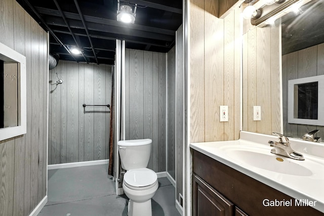3725 Colby Ave SW, Wyoming, MI 49509 - bathroom featuring wooden walls, vanity, and concrete flooring