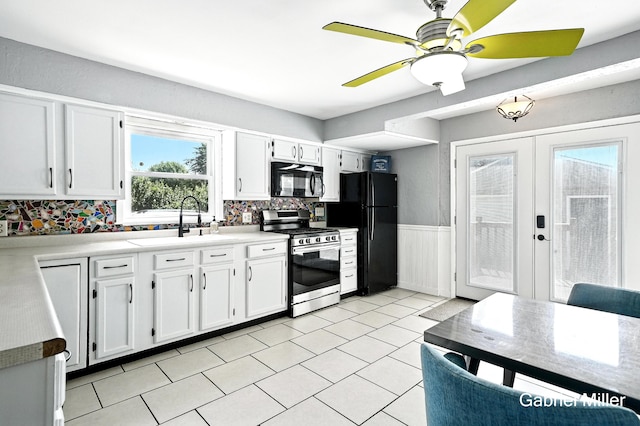 3725 Colby Ave SW, Wyoming, MI 49509 - kitchen featuring black appliances, white cabinets, wainscoting, light countertops, and a ceiling fan