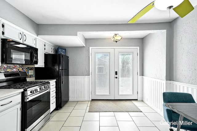 3725 Colby Ave SW, Wyoming, MI 49509 - kitchen featuring black appliances, french doors, wainscoting, light countertops, and white cabinets