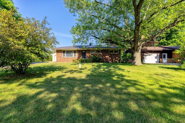 1762 Smyers Dr, Benton Harbor, MI 49022 - view of grassy yard with an attached garage