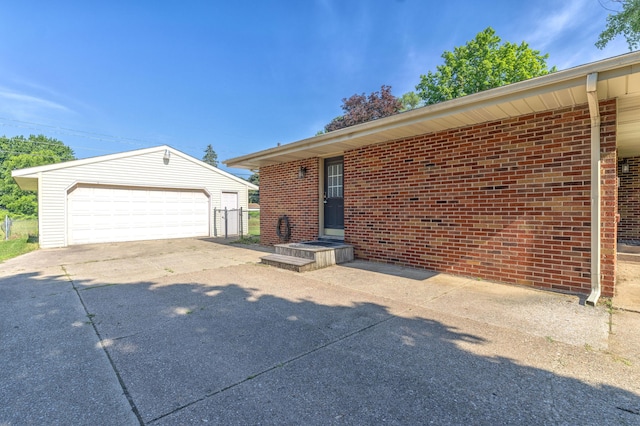 1762 Smyers Dr, Benton Harbor, MI 49022 - view of front of property featuring an outbuilding, a garage, and brick siding