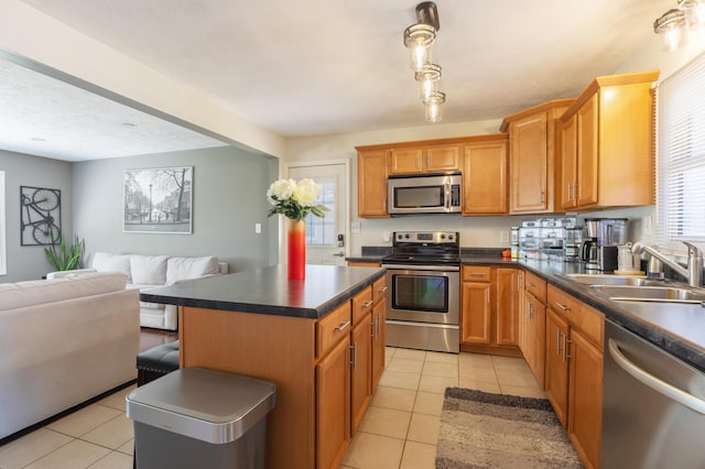 1762 Smyers Dr, Benton Harbor, MI 49022 - kitchen with stainless steel appliances, light tile patterned flooring, dark countertops, and open floor plan