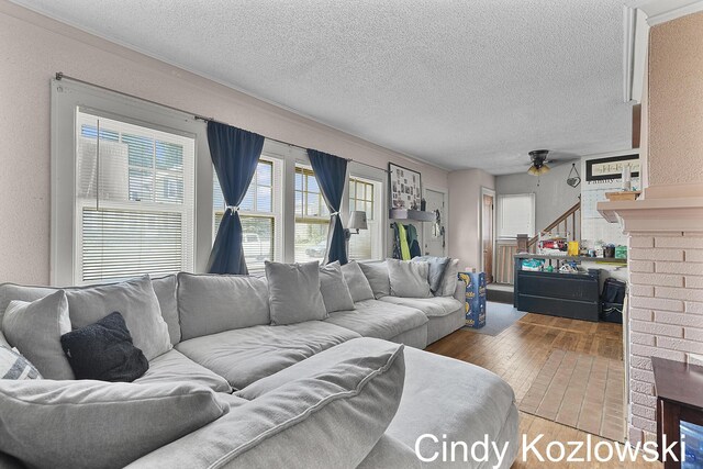 187 Centennial St, Sparta, MI 49345 - living room with hardwood / wood-style floors, a ceiling fan, and a textured ceiling