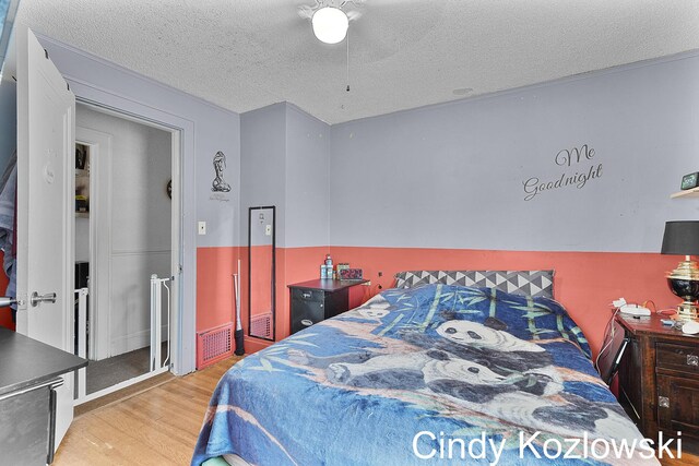 187 Centennial St, Sparta, MI 49345 - bedroom featuring wood finished floors and a textured ceiling