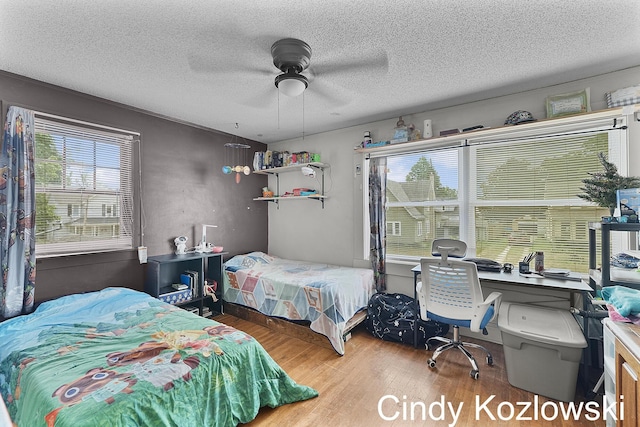 187 Centennial St, Sparta, MI 49345 - bedroom featuring wood finished floors, a textured ceiling, a desk, and ceiling fan