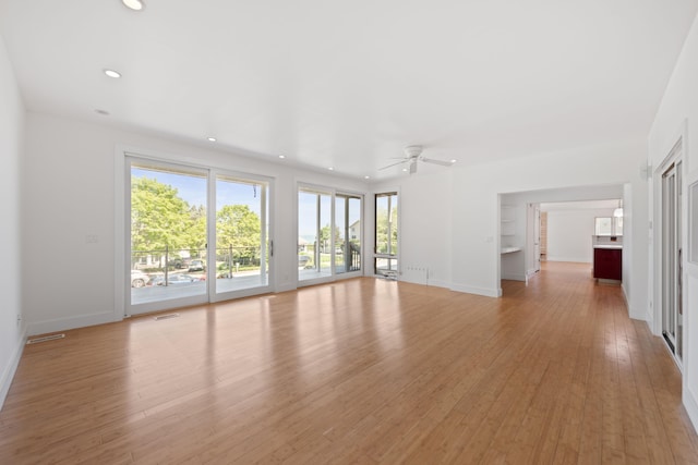 48002 Ridge Rd, New Buffalo, MI 49117 - unfurnished living room featuring a ceiling fan, plenty of natural light, light wood finished floors, and recessed lighting