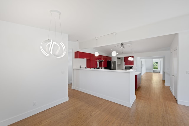 48002 Ridge Rd, New Buffalo, MI 49117 - kitchen featuring freestanding refrigerator, a ceiling fan, light wood-type flooring, under cabinet range hood, and wall oven